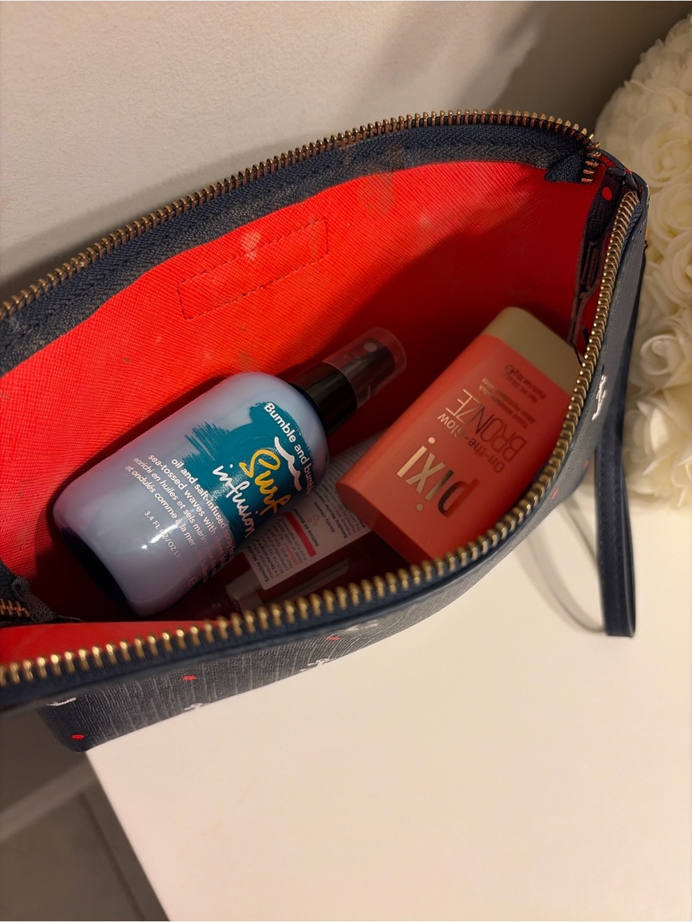 Tommy Hilfiger pouch with products